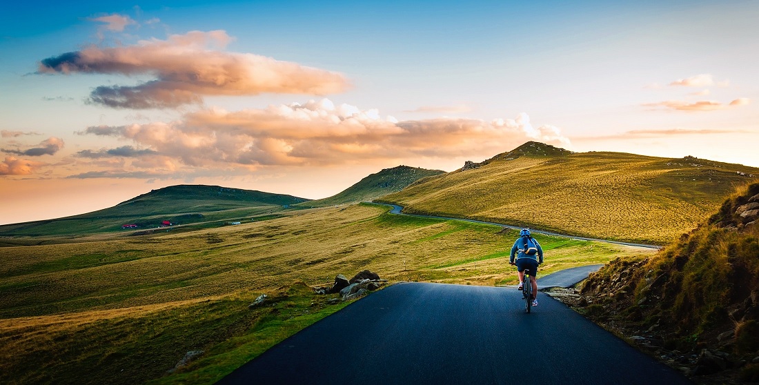 rear-view-of-man-on-mountain-road-against-sky-258045.jpg