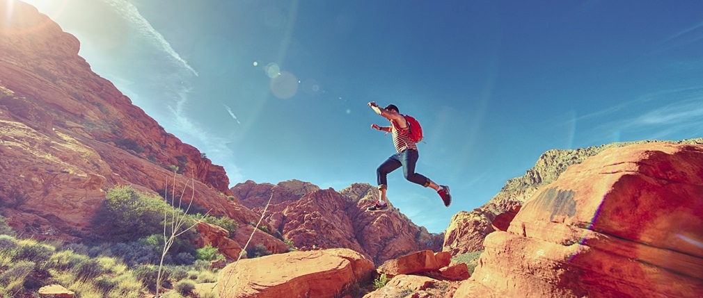 a man leaping from rock to rock, quite joyously